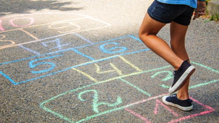 child playing hopscotch