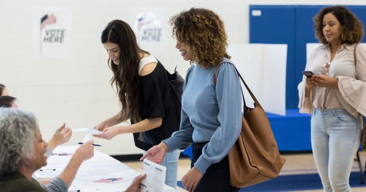 People at a table to vote