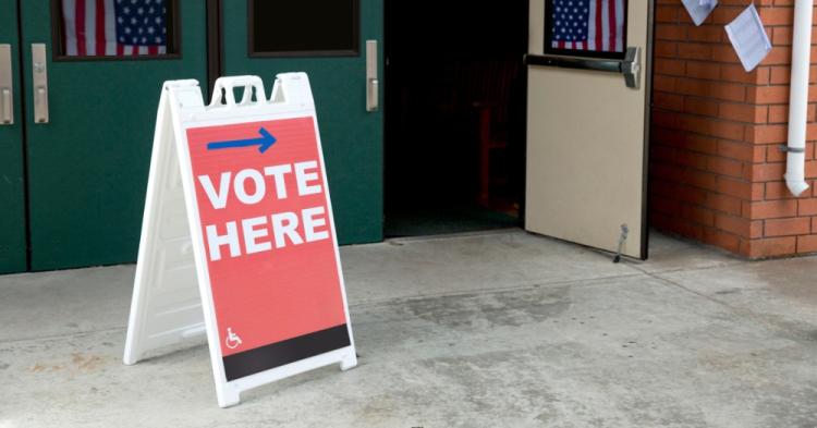 Polling location with "vote here" sign 