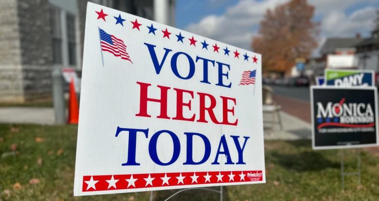Sign that reads "Vote Here Today"
