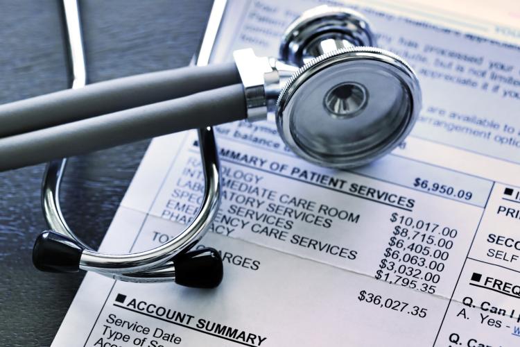 Stethoscope on top of hospital invoice detailing charges
