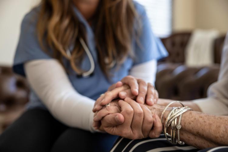 Nurse holding hand of an elderly person