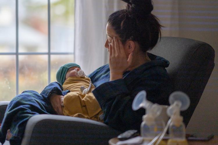 Exhausted mother holding a baby