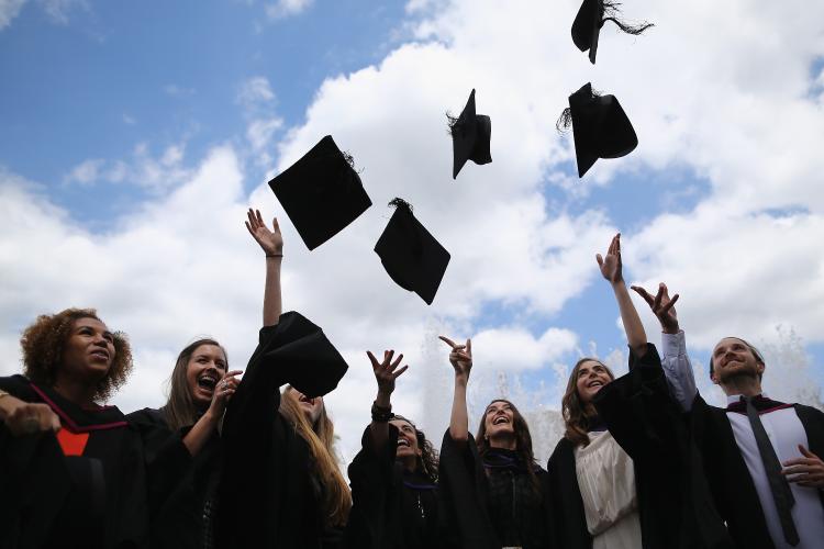 Graduates throwing caps in the air 