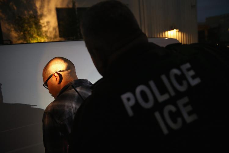 Person getting detained by ICE agent 