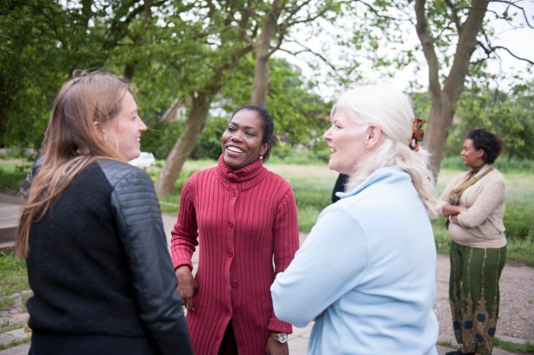 Three woman in a small circle, discussing