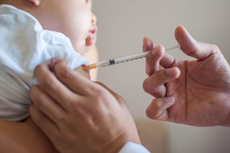 Baby getting immunization shot.