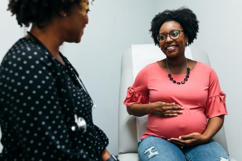 Pregnant person talking to doctor 