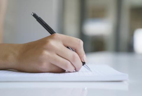 Hand with pen writing