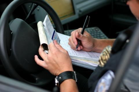 Police officer signing a ticket 