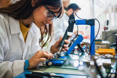 woman working on circuit board