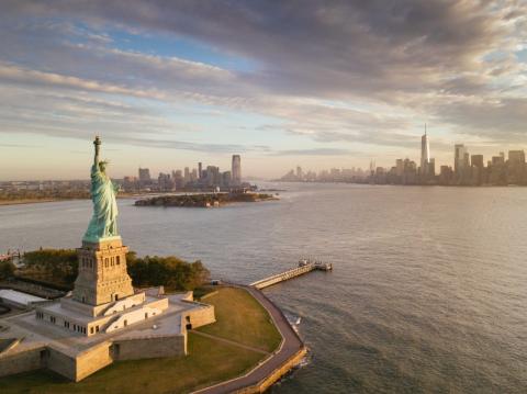 Statue of Liberty, Ellis Island with New York City  skyline in the background