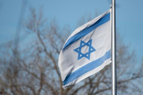 Flag of Israel waving on a flag pole