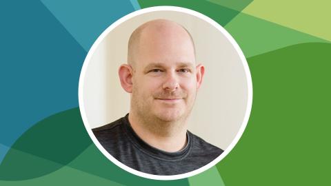 Headshot of Daniel Collier against SSN's blue-green texture file