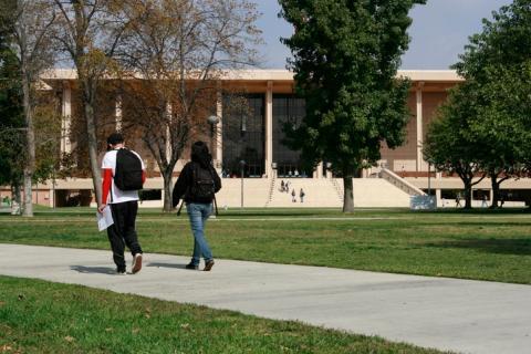 two students walking on a college campus 