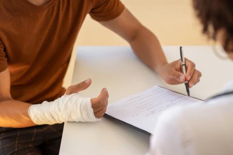 hurt patient filling out medical paperwork
