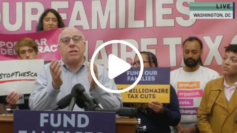 Screenshot of Harry Holzer mid-speech with play button on top, indicating that this image is from a video