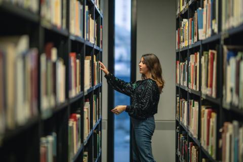 student looking for books at the library 
