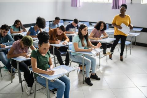 Adolescent students in a high school classroom taking an exam