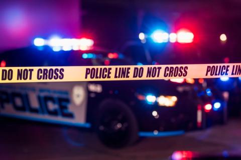 crime scene with police tape in focus 