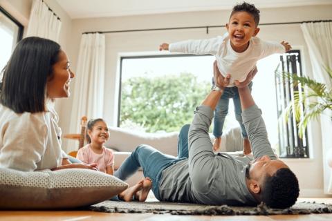 two parents playing with their two kids