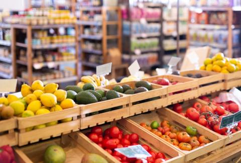 Vegetables in a grocery store displayed in wooden crates, boxes