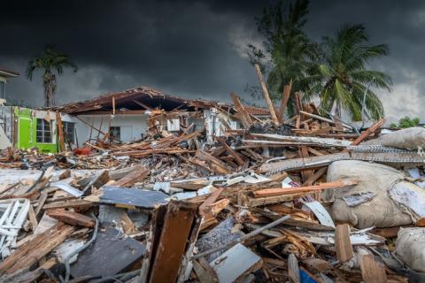 Wrecked homes after natural disaster, dark skies 