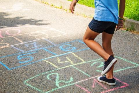 child playing hop scotch 