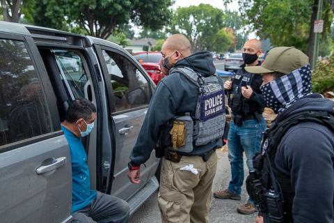 man being detained by ice officials
