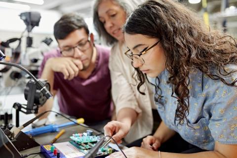 group of young people collaborating on a science project