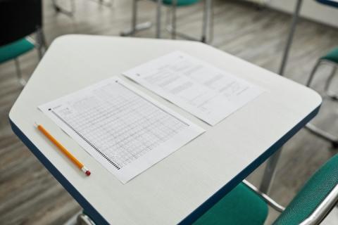 Standardized test on a students desk with a pencil 