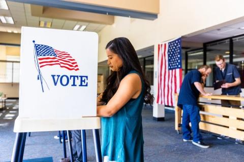 Woman voting in school board election