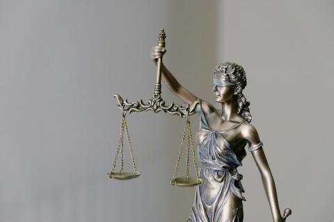 Small statue of lady justice, lady blindfolded and carrying scales    