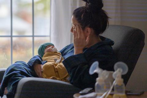 Exhausted mother holding a baby