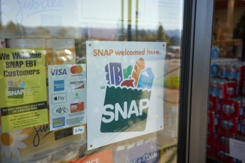 "SNAP welcomed here" sign on shop window/door 