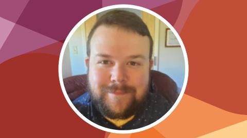 Headshot of Joshua Mangin against SSN's red-purple texture file background