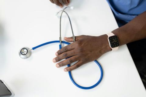 physician hand holding a stethoscope