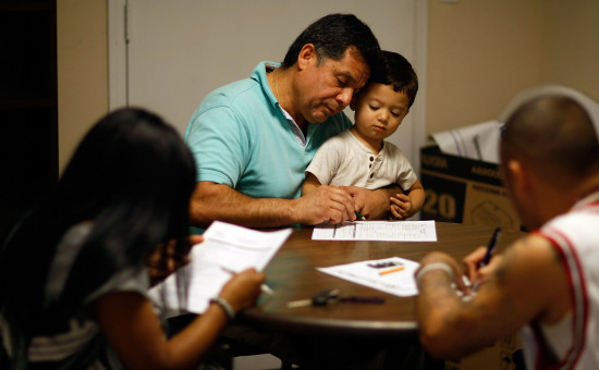 Members of a family filling out forms