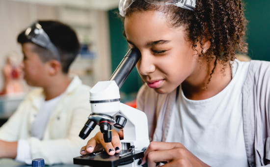 Child looking through microscope 