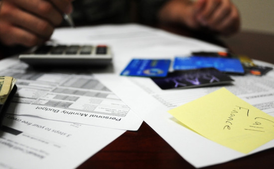 Debt bills, credit cards, and calculator on a table