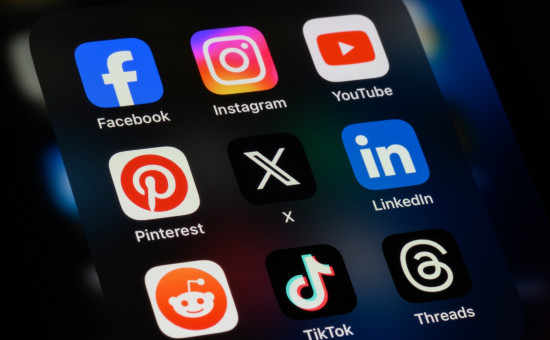 Phone with many social media apps including Facebook, Instagram, YouTube and more